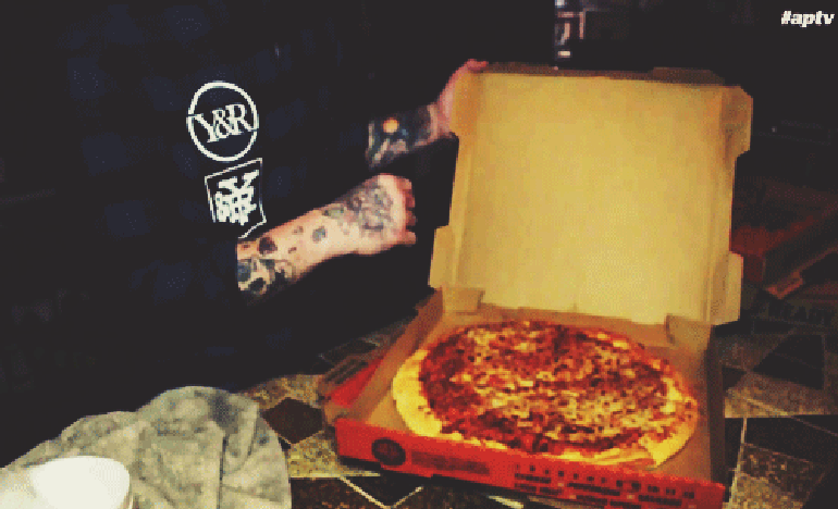 Jonny Monroe Craig eating a pizza